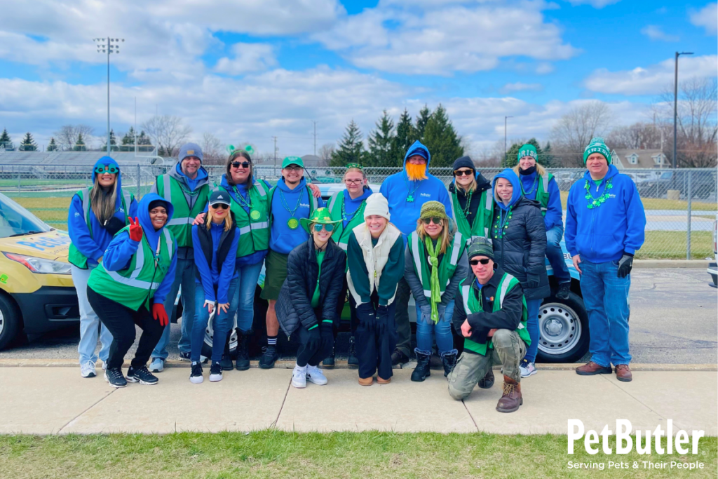 Pet Butler employees posing for a group photo at St. Patrick's Day parade in their local community.