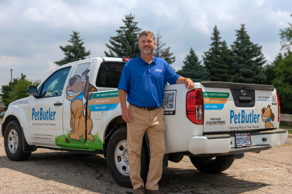 Pet Butler franchise owner standing in front of Pet Butler pickup truck.