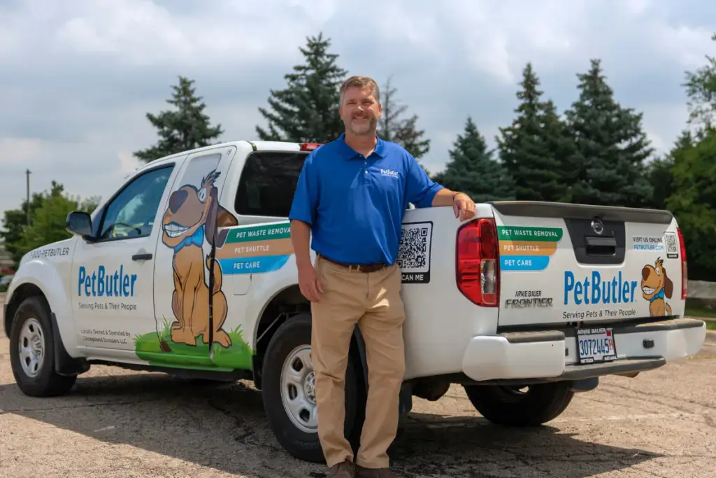 Pet Butler franchise owner standing in front of Pet Butler pickup truck.