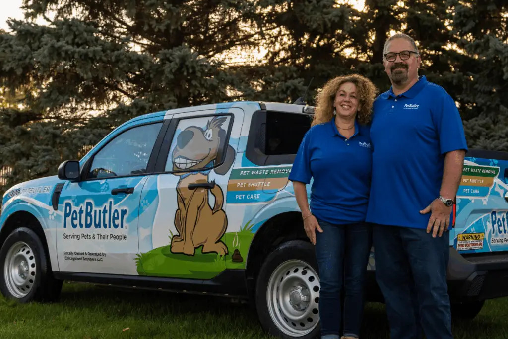 Pet Butler franchise owners standing in front of their Pet Butler service truck
