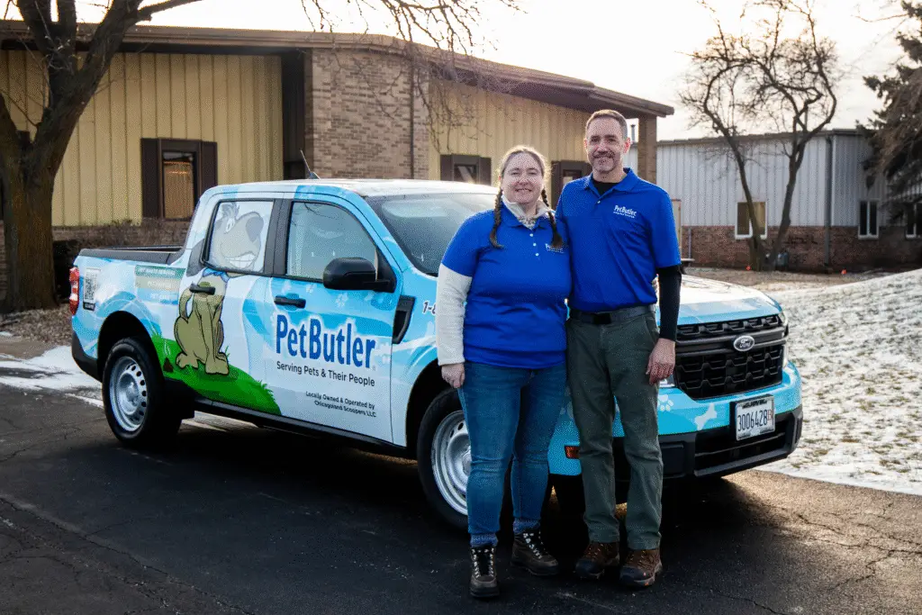 pet butler franchise owners Todd and Kelley Simon standing in front of Pet Butler truck