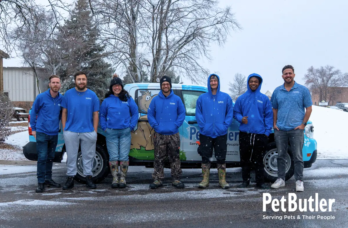 Pet Butler team standing in front of Pet Butler truck on a snowy day