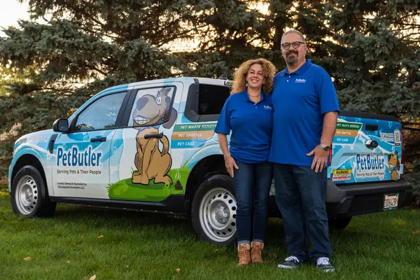 Pet Butler owners standing and posing in front of Pet Butler truck