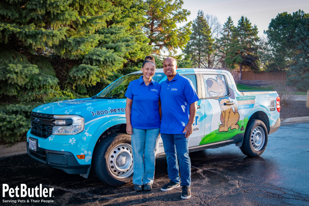 Pet Butler owners standing and posing in front of Pet Butler truck
