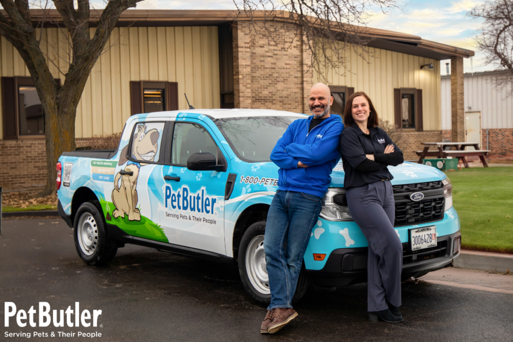 Pet Butler franchise owners posing in front of Pet Butler truck