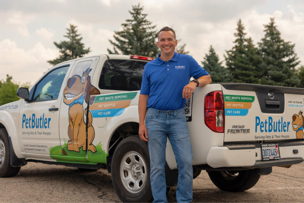 Pet Butler business owner standing in front of Pet Butler truck