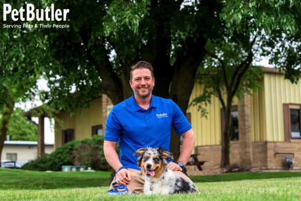 Pet Butler Franchise Owner with dog sitting on the grass
